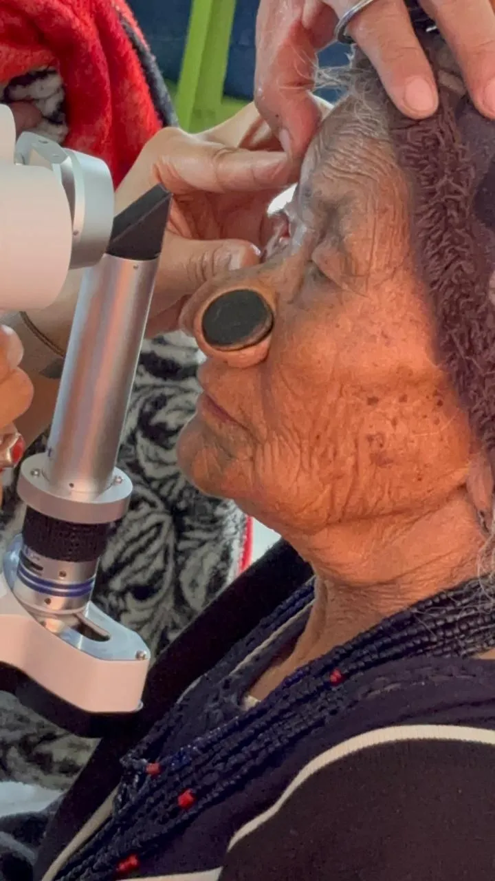 Optometrist conducting refraction screening for distance vision.